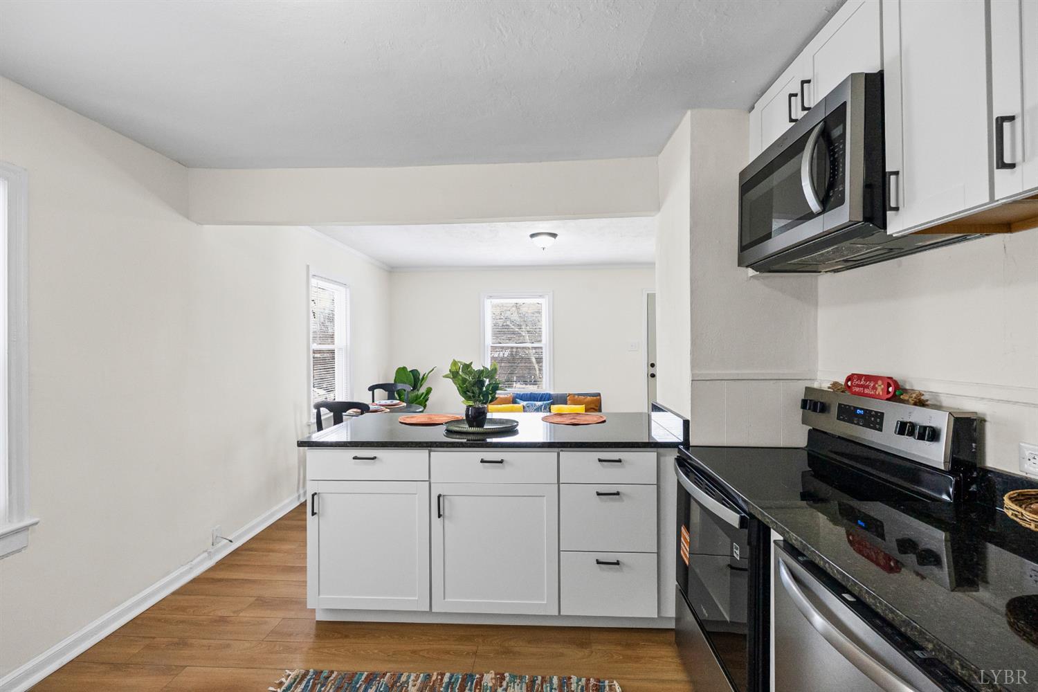 1209 Shirley Road Lynchburg, VA 24502 - Photo 11 of 27 a kitchen with stainless steel appliances white cabinets and a stove top oven