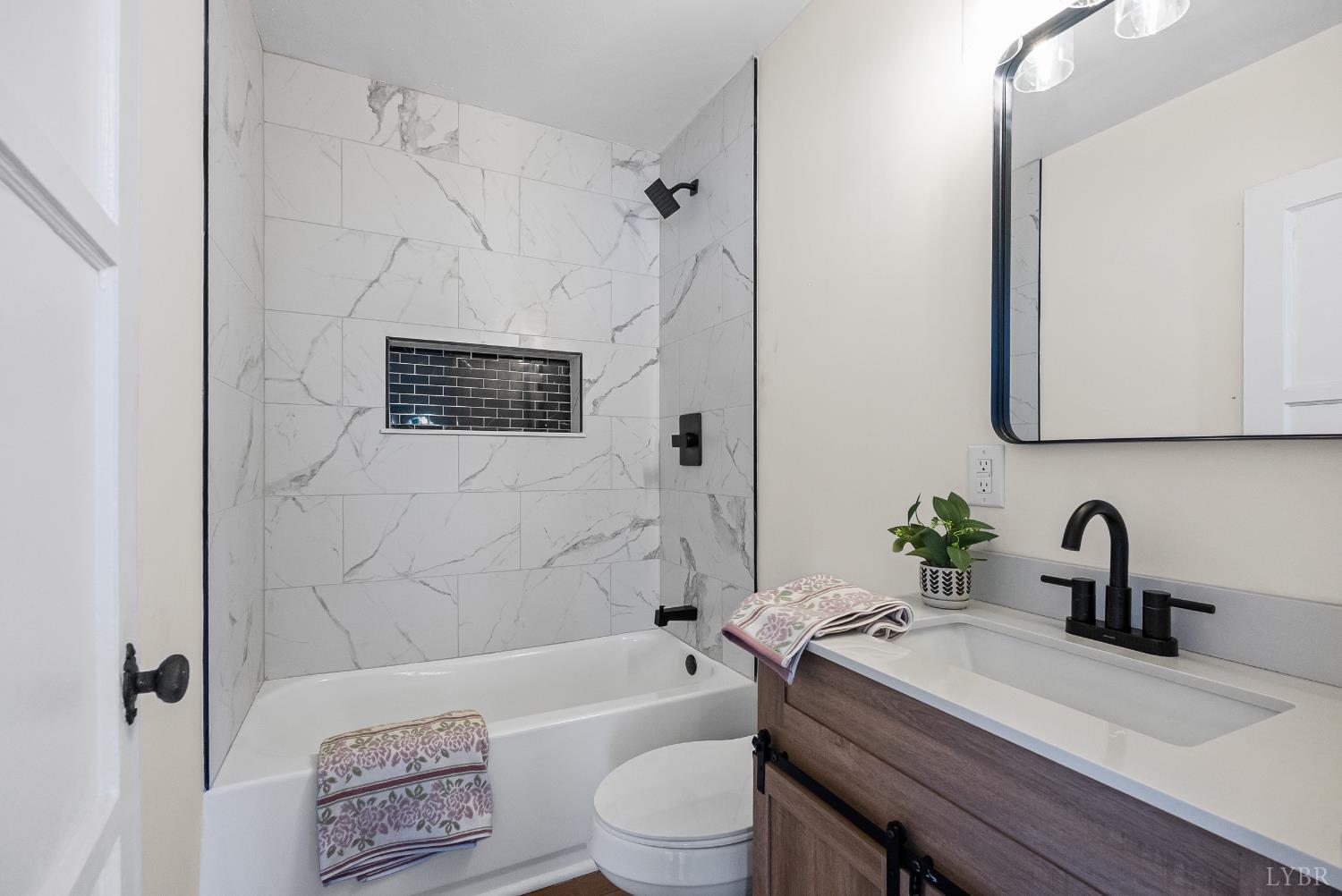 1209 Shirley Road Lynchburg, VA 24502 - Photo 17 of 27 a bathroom with a sink a toilet and a bathtub