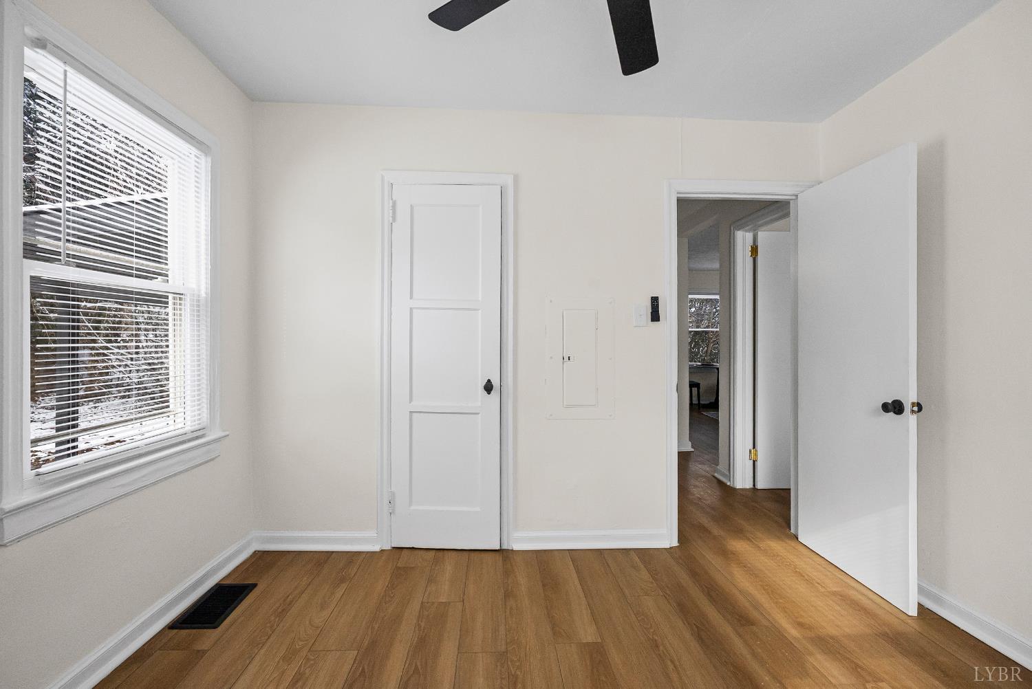 1209 Shirley Road Lynchburg, VA 24502 - Photo 19 of 27 a view of an empty room with wooden floor and a window