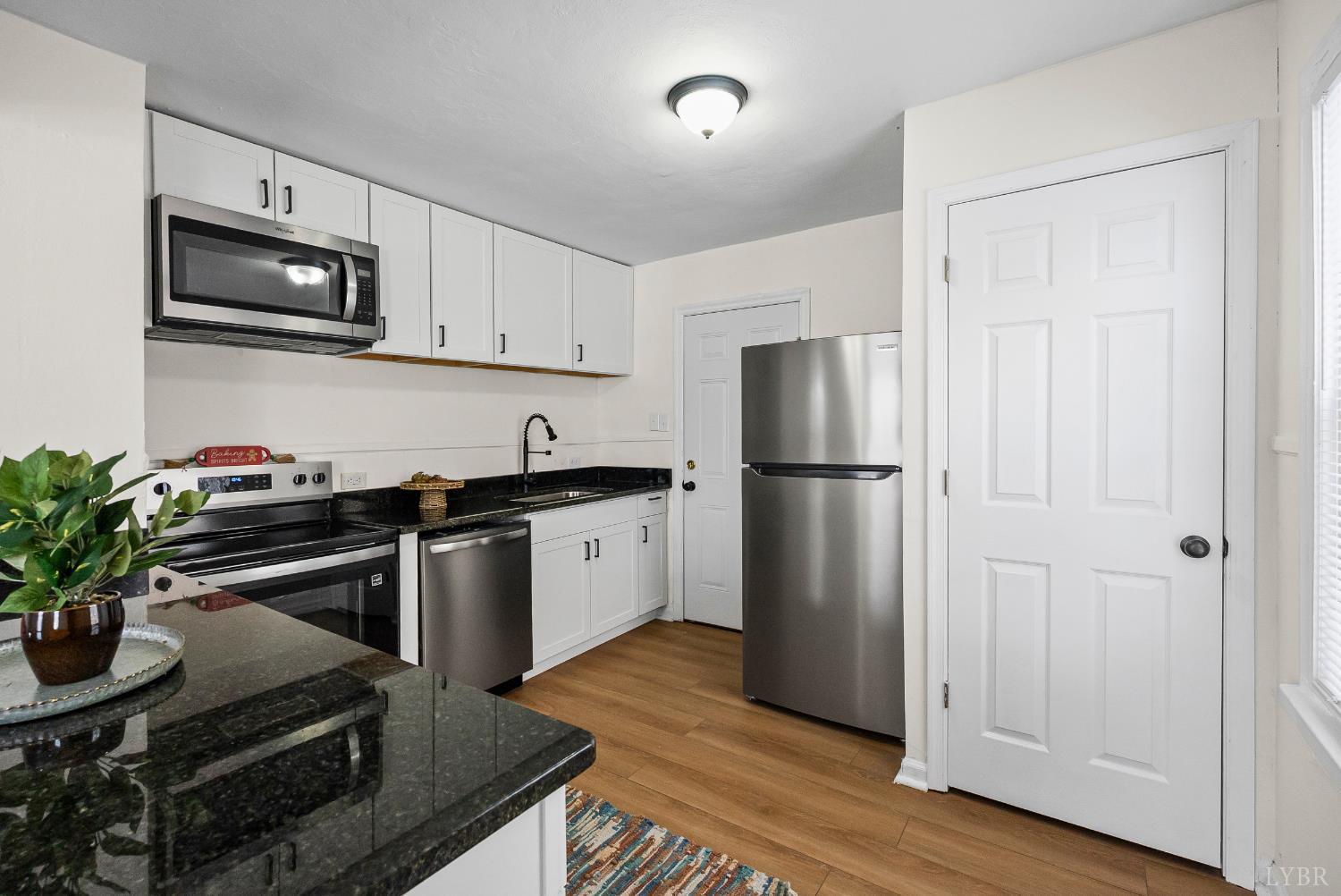 1209 Shirley Road Lynchburg, VA 24502 - Photo 9 of 27 a kitchen with a refrigerator stainless steel appliances and cabinets