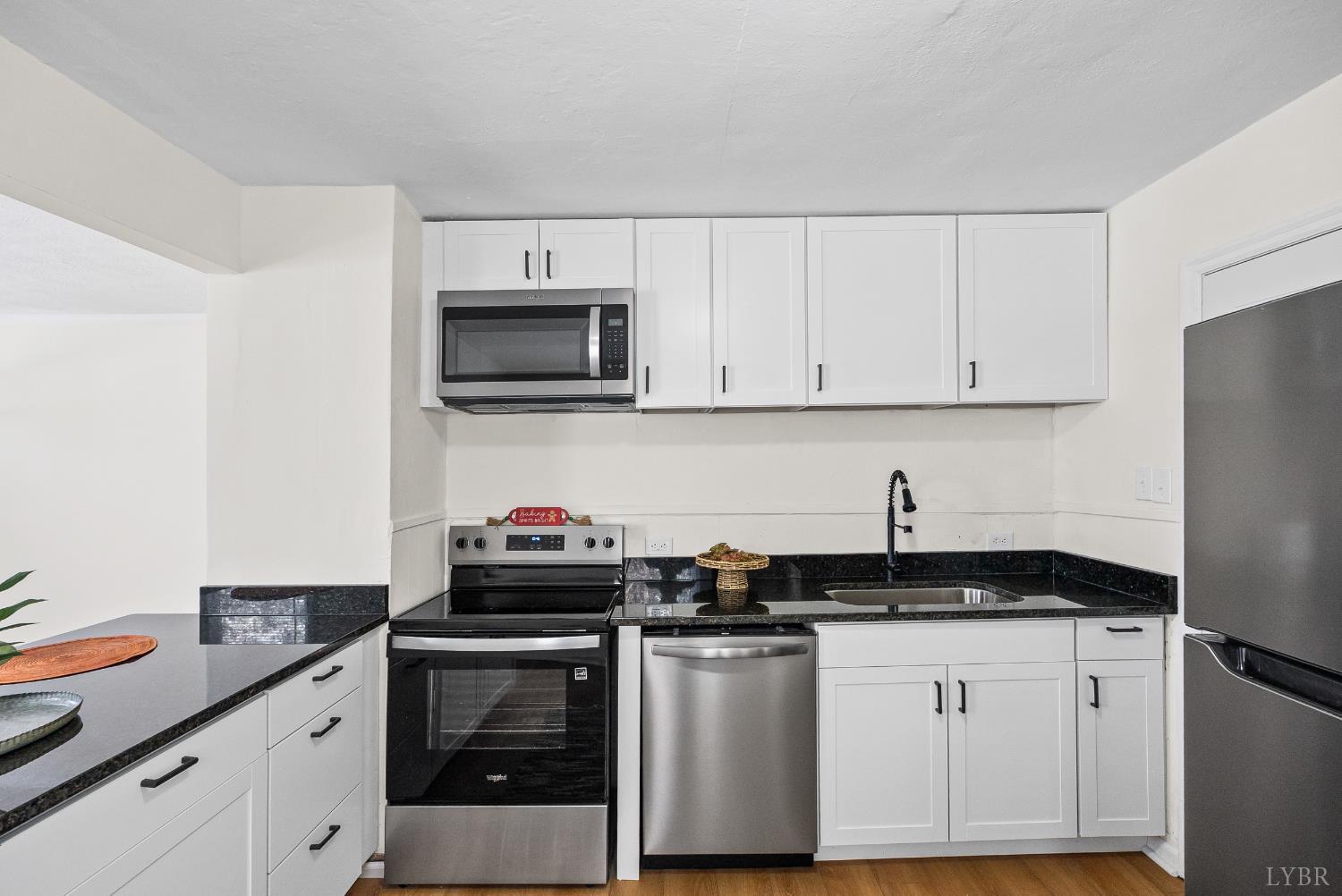 1209 Shirley Road Lynchburg, VA 24502 - Photo 10 of 27 a kitchen with granite countertop white cabinets and stainless steel appliances