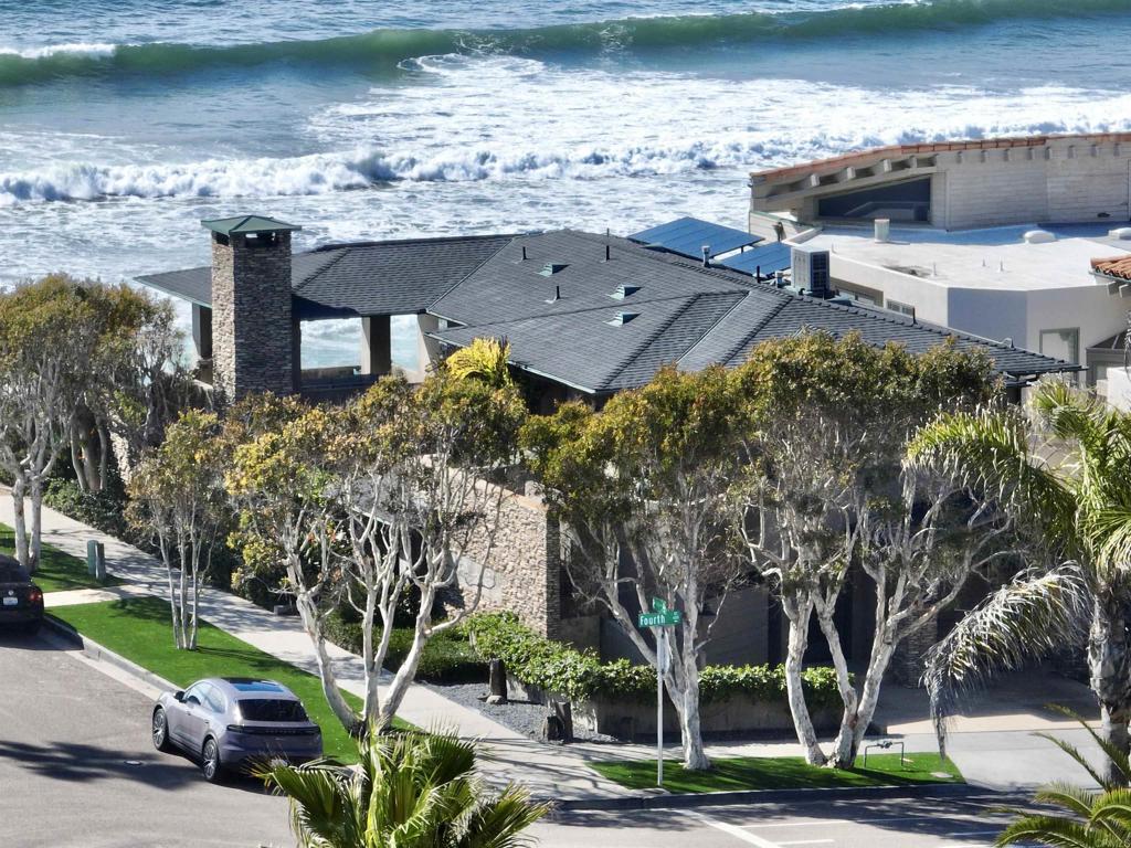 an aerial view of a house with a lake view