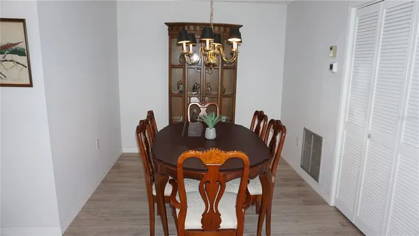 a dining room with furniture and wooden floor