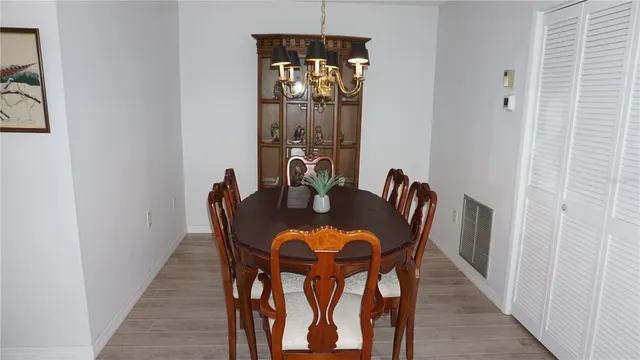 a dining room with furniture and wooden floor