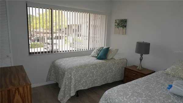 a bedroom with bed and window