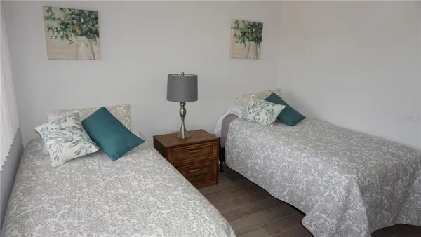 a bed sitting in a bedroom and painting on the wall