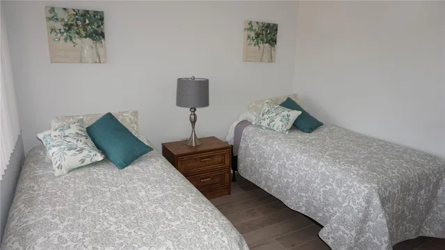 a bed sitting in a bedroom and painting on the wall