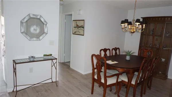 a view of a dining room with furniture and chandelier