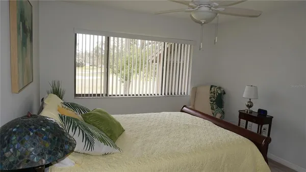 a bed sitting in a bedroom next to a window