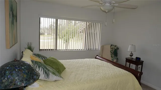 a bed sitting in a bedroom next to a window