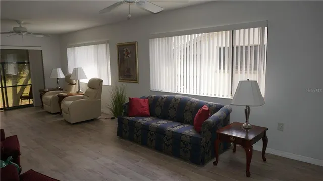 a living room with furniture and a lamp