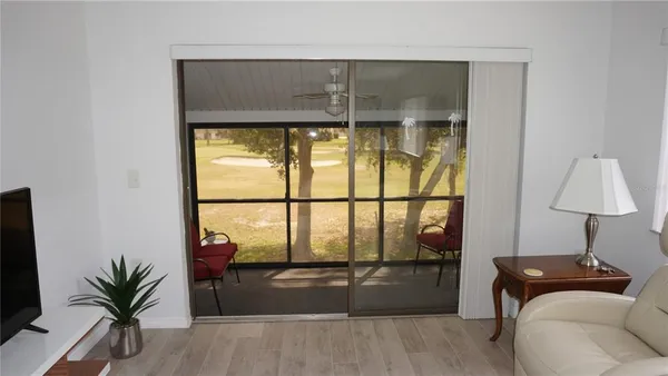 a living room with a large window and table