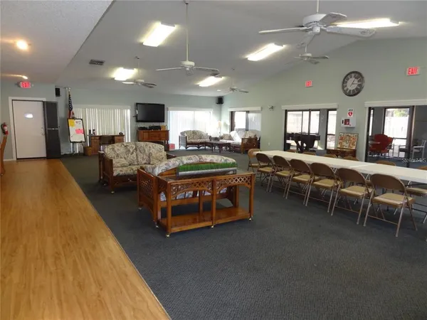 a living room with lots of furniture and a large window