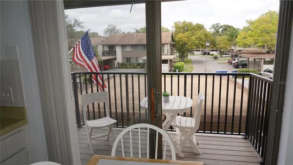 a view of a balcony with wooden floor