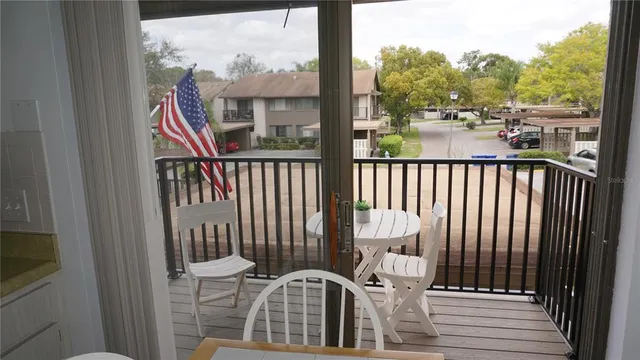a view of a balcony with wooden floor