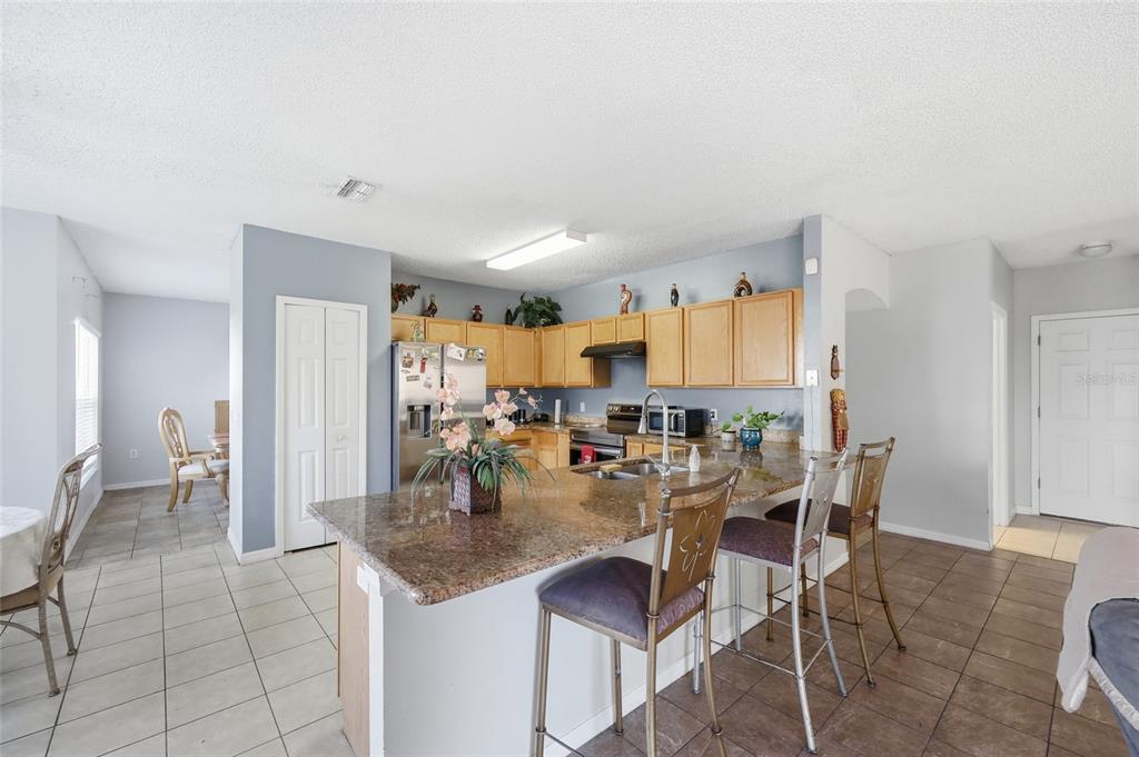 547 Brighton Court Kissimmee, FL 34758 - Photo 12 of 36 a view of a dining room with furniture