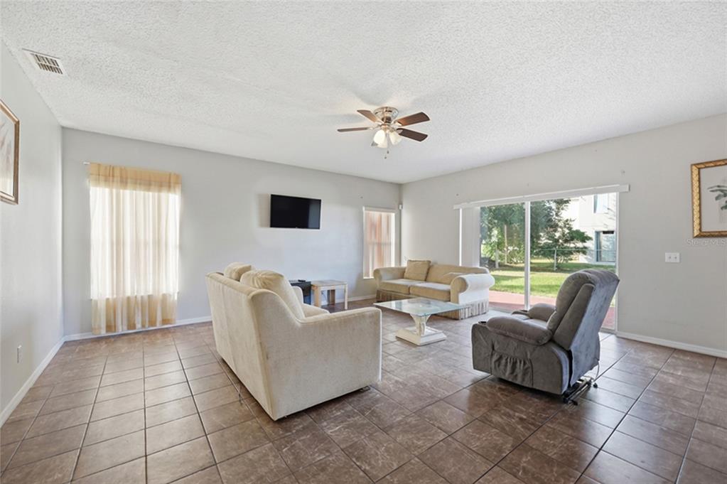 547 Brighton Court Kissimmee, FL 34758 - Photo 13 of 36 a living room with furniture and a large window