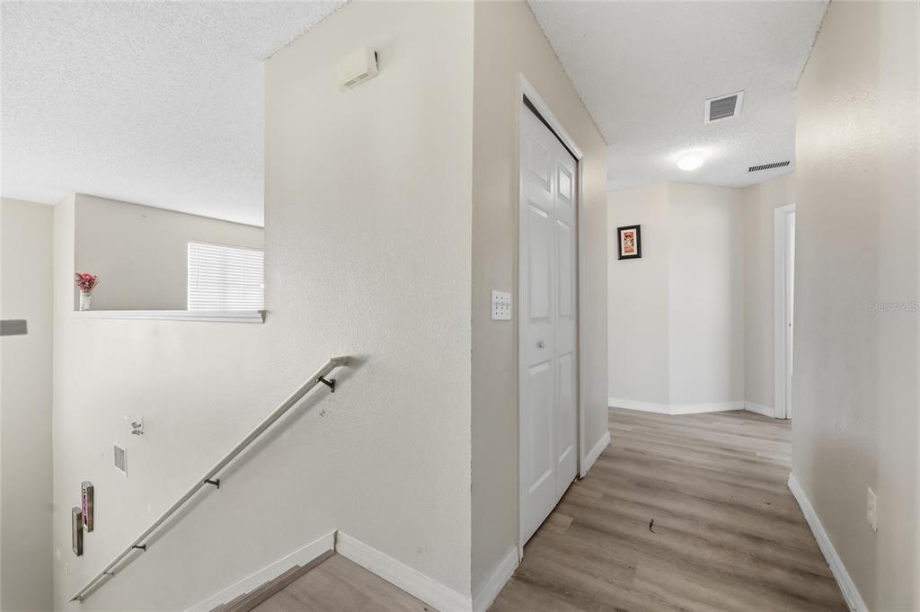 547 Brighton Court Kissimmee, FL 34758 - Photo 16 of 36 a view of a hallway with wooden floor