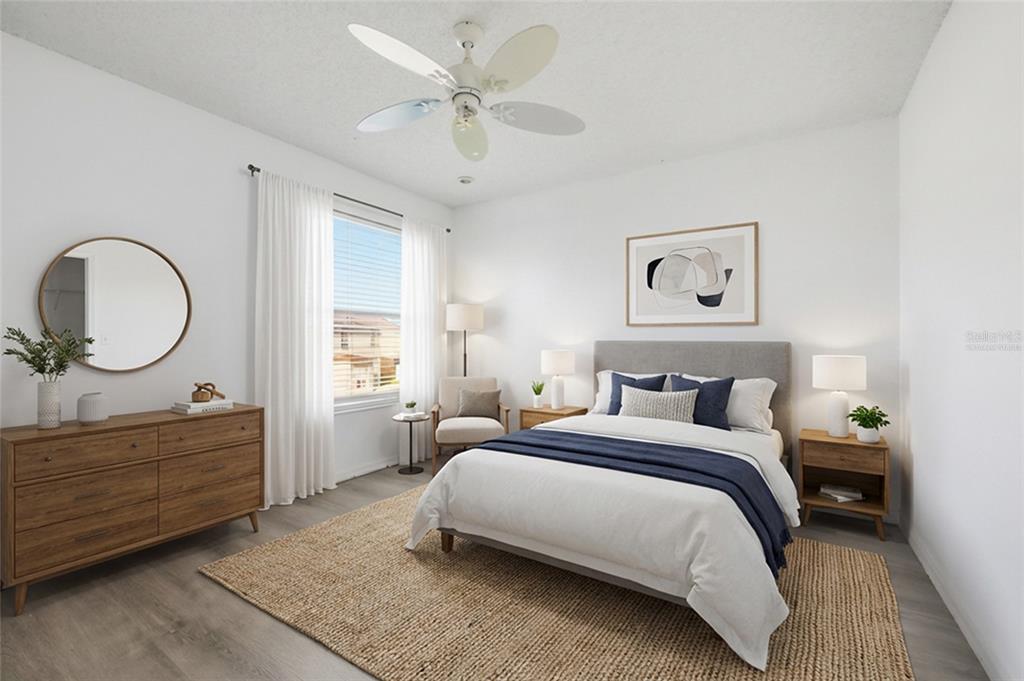 547 Brighton Court Kissimmee, FL 34758 - Photo 19 of 36 a bedroom with a bed mirror and a window