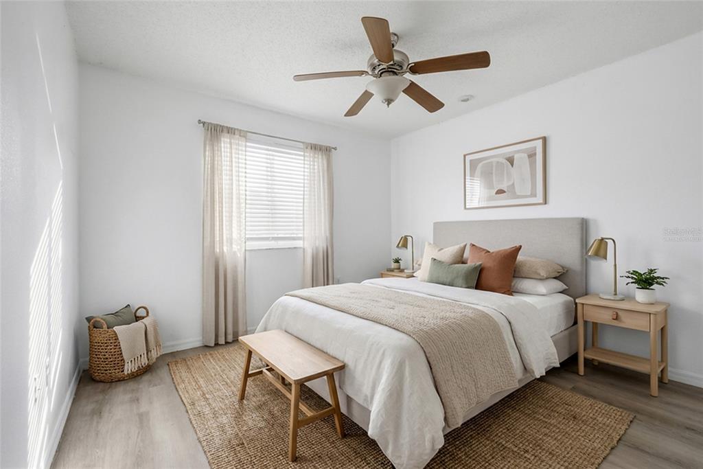 547 Brighton Court Kissimmee, FL 34758 - Photo 21 of 36 a bedroom with a bed a couch and a window