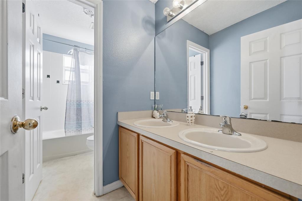 547 Brighton Court Kissimmee, FL 34758 - Photo 23 of 36 a bathroom with a sink and a mirror