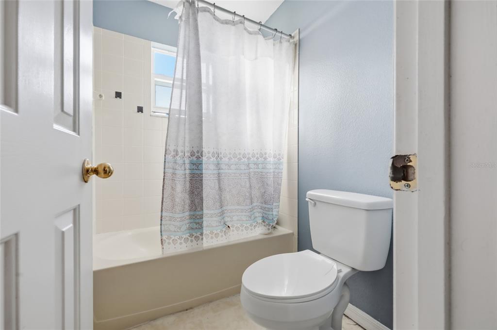 547 Brighton Court Kissimmee, FL 34758 - Photo 24 of 36 a white toilet sitting next to a bathroom sink