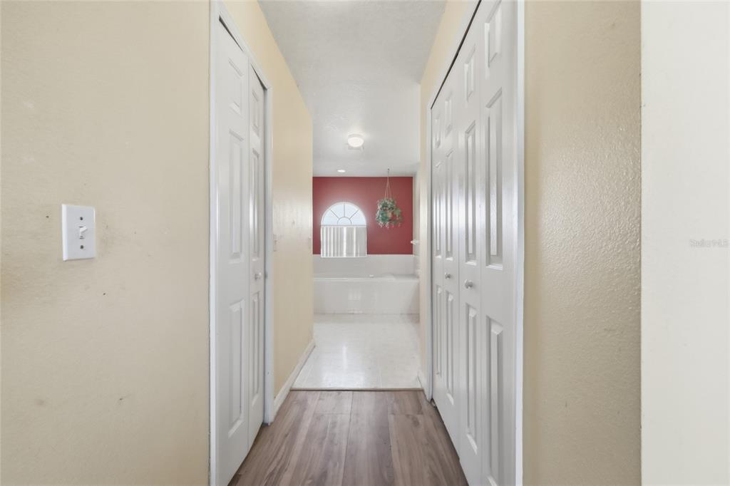 547 Brighton Court Kissimmee, FL 34758 - Photo 27 of 36 a view of a hallway with wooden floor