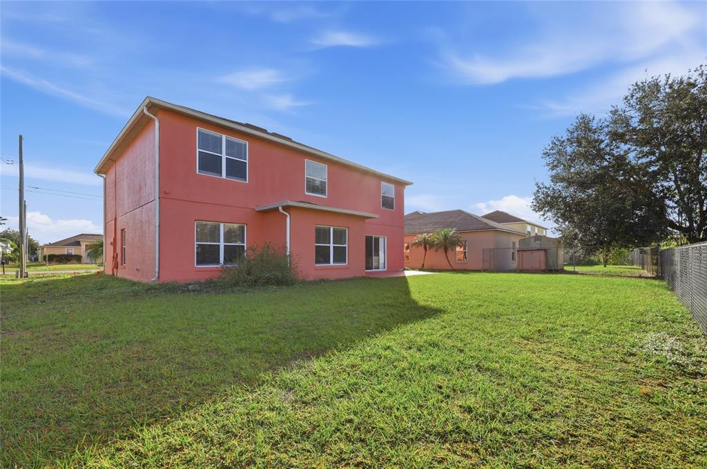547 Brighton Court Kissimmee, FL 34758 - Photo 32 of 36 a view of a yard in front of a house with large trees
