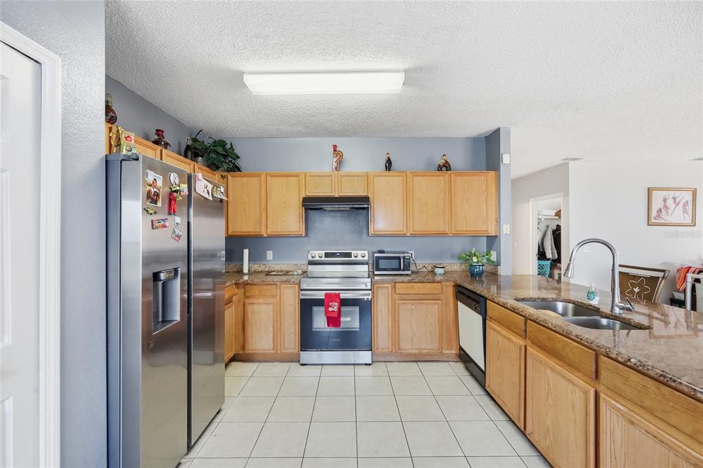 547 Brighton Court Kissimmee, FL 34758 - Photo 10 of 36 a kitchen with a sink stove and refrigerator