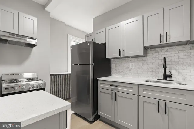 a kitchen with appliances and cabinets