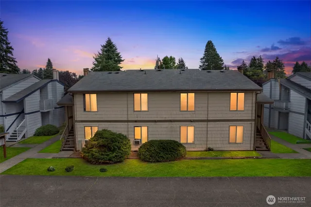 a front view of a residential houses with yard