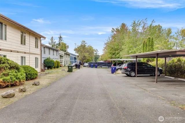 a view of road with card and parked car