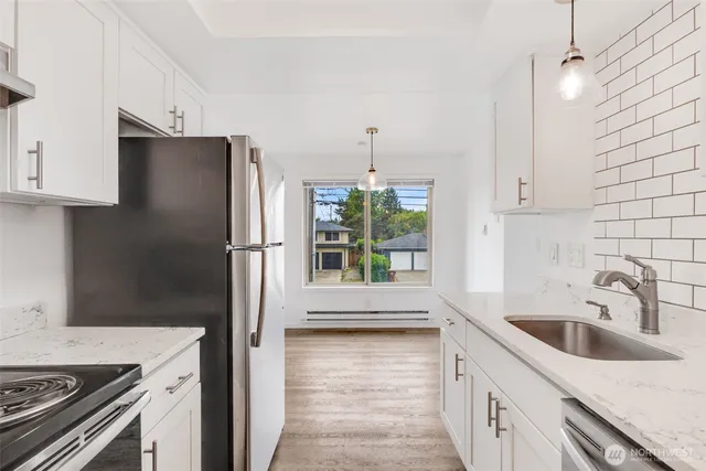 a kitchen with a sink stove and refrigerator