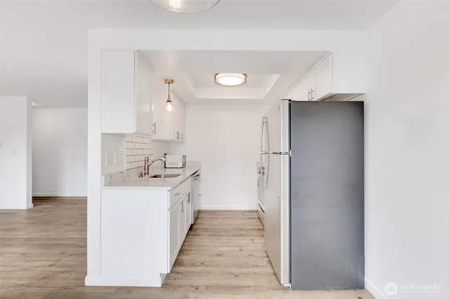 a kitchen with a sink and a refrigerator