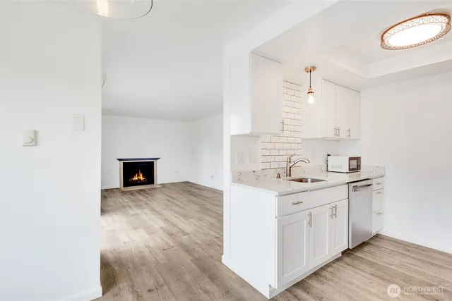 a kitchen with a sink cabinets and wooden floor