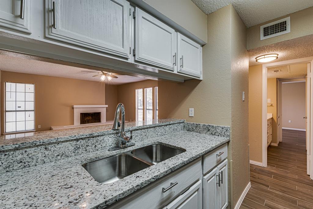 9611 Walnut Street, Unit 1106 Dallas, TX 75081 - Photo 15 of 31 a kitchen with stainless steel appliances granite countertop a sink and cabinets