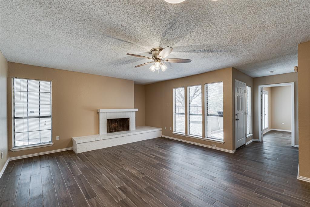 9611 Walnut Street, Unit 1106 Dallas, TX 75081 - Photo 19 of 31 an empty room with wooden floor a ceiling fan and windows