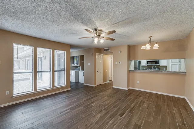 a view of a kitchen with a dishwasher cabinets and wooden floor