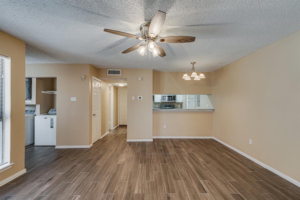 9611 Walnut Street, Unit 1106 Dallas, TX 75081 - Photo 21 of 31 a view of a kitchen with a dishwasher cabinets and wooden floor