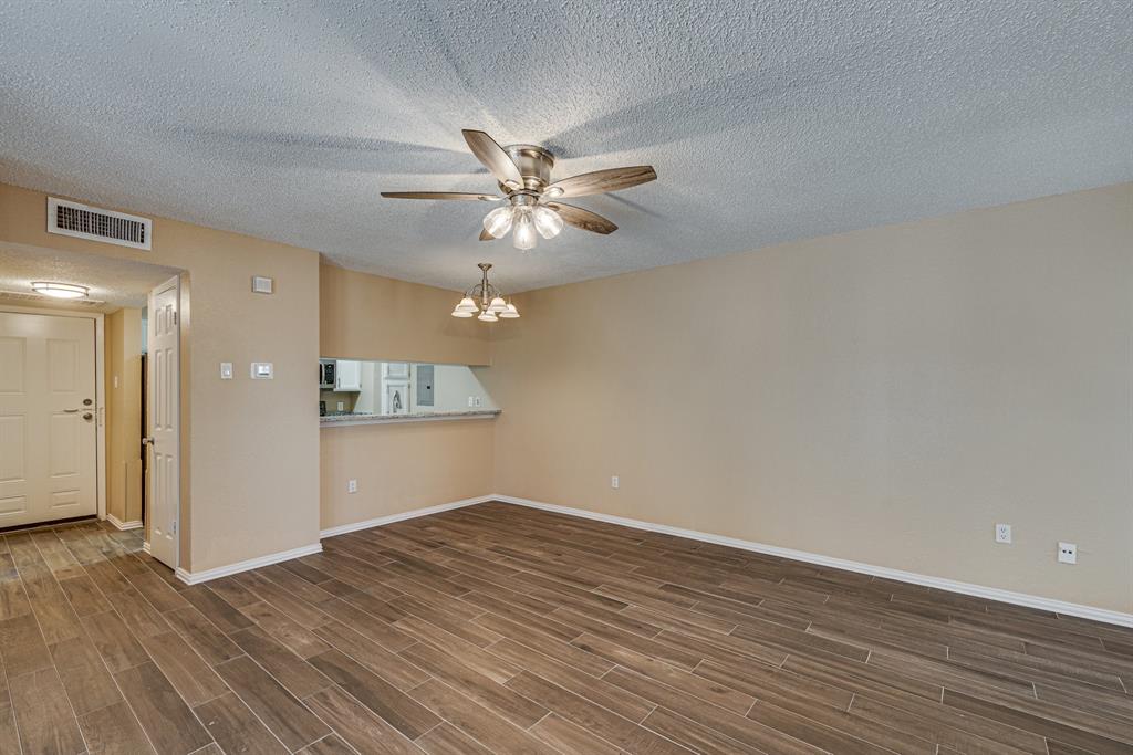 9611 Walnut Street, Unit 1106 Dallas, TX 75081 - Photo 22 of 31 a view of an empty room with wooden floor