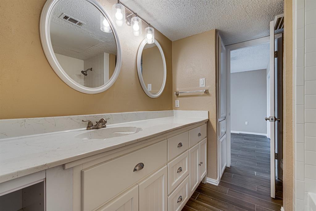 9611 Walnut Street, Unit 1106 Dallas, TX 75081 - Photo 25 of 31 a bathroom with a granite countertop double vanity sink and a mirror