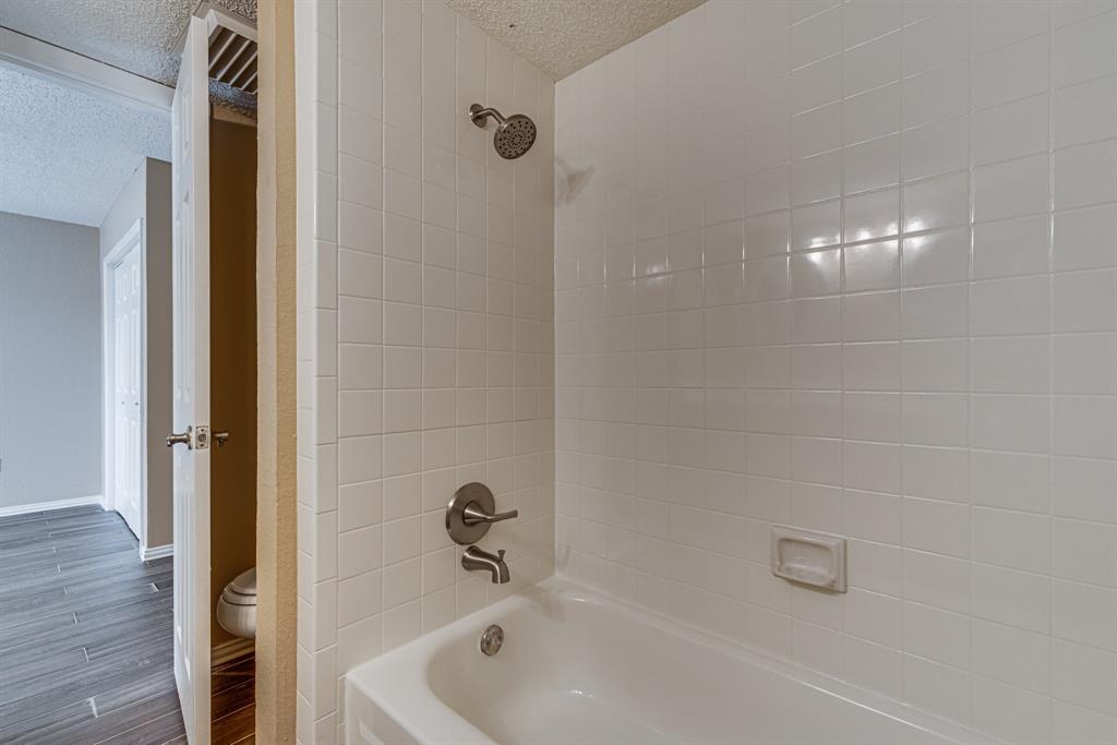 9611 Walnut Street, Unit 1106 Dallas, TX 75081 - Photo 26 of 31 a bathroom with a tub and shower