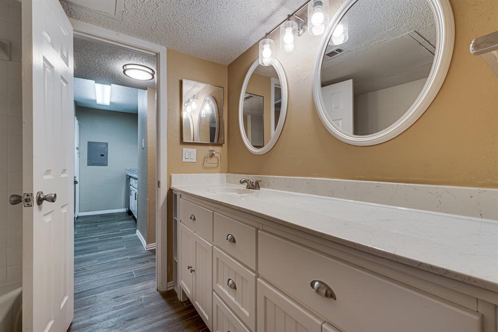 9611 Walnut Street, Unit 1106 Dallas, TX 75081 - Photo 27 of 31 a bathroom with a double vanity sink and a mirror