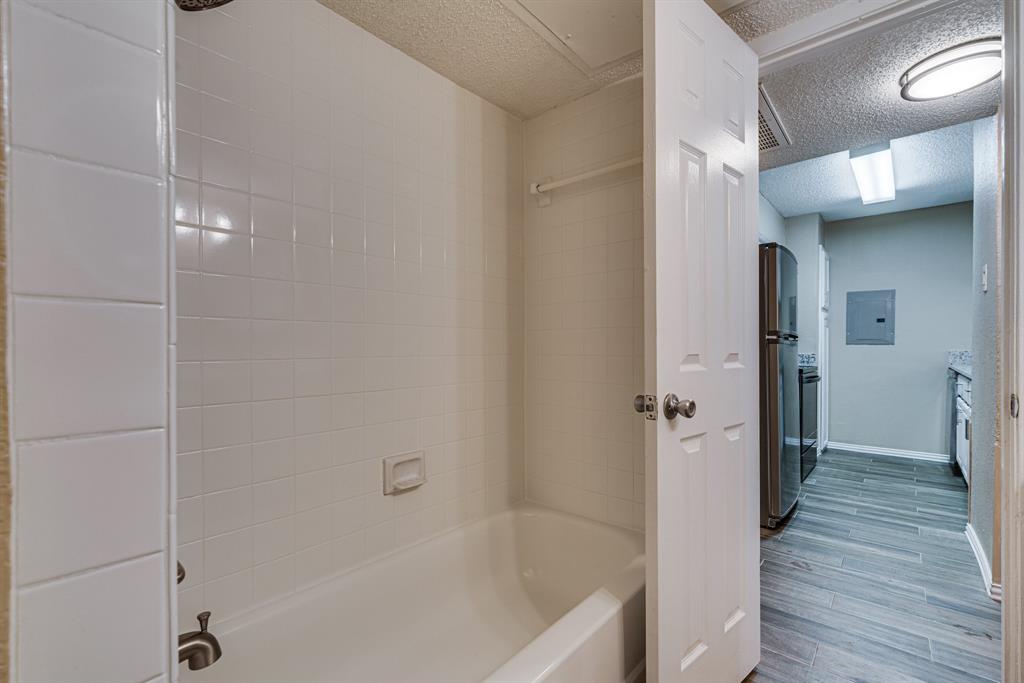 9611 Walnut Street, Unit 1106 Dallas, TX 75081 - Photo 29 of 31 a bathroom with a bathtub and a shower