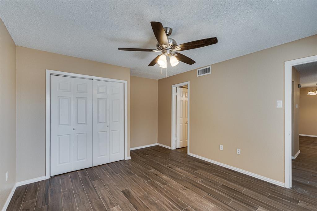 9611 Walnut Street, Unit 1106 Dallas, TX 75081 - Photo 6 of 31 a view of empty room with wooden floor and fan