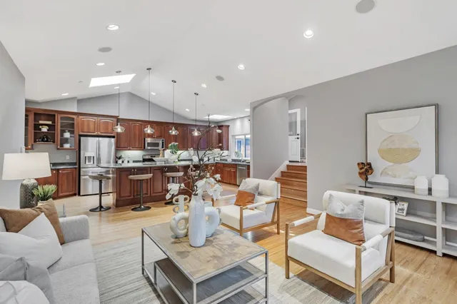 a living room with furniture and kitchen view