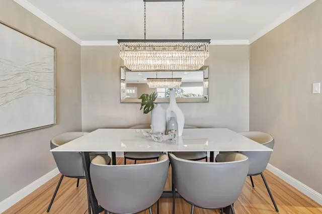 a large kitchen with kitchen island granite countertop wooden floors and a sink