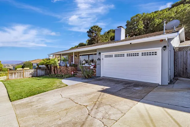 a living room with furniture a wooden floor and next to a window