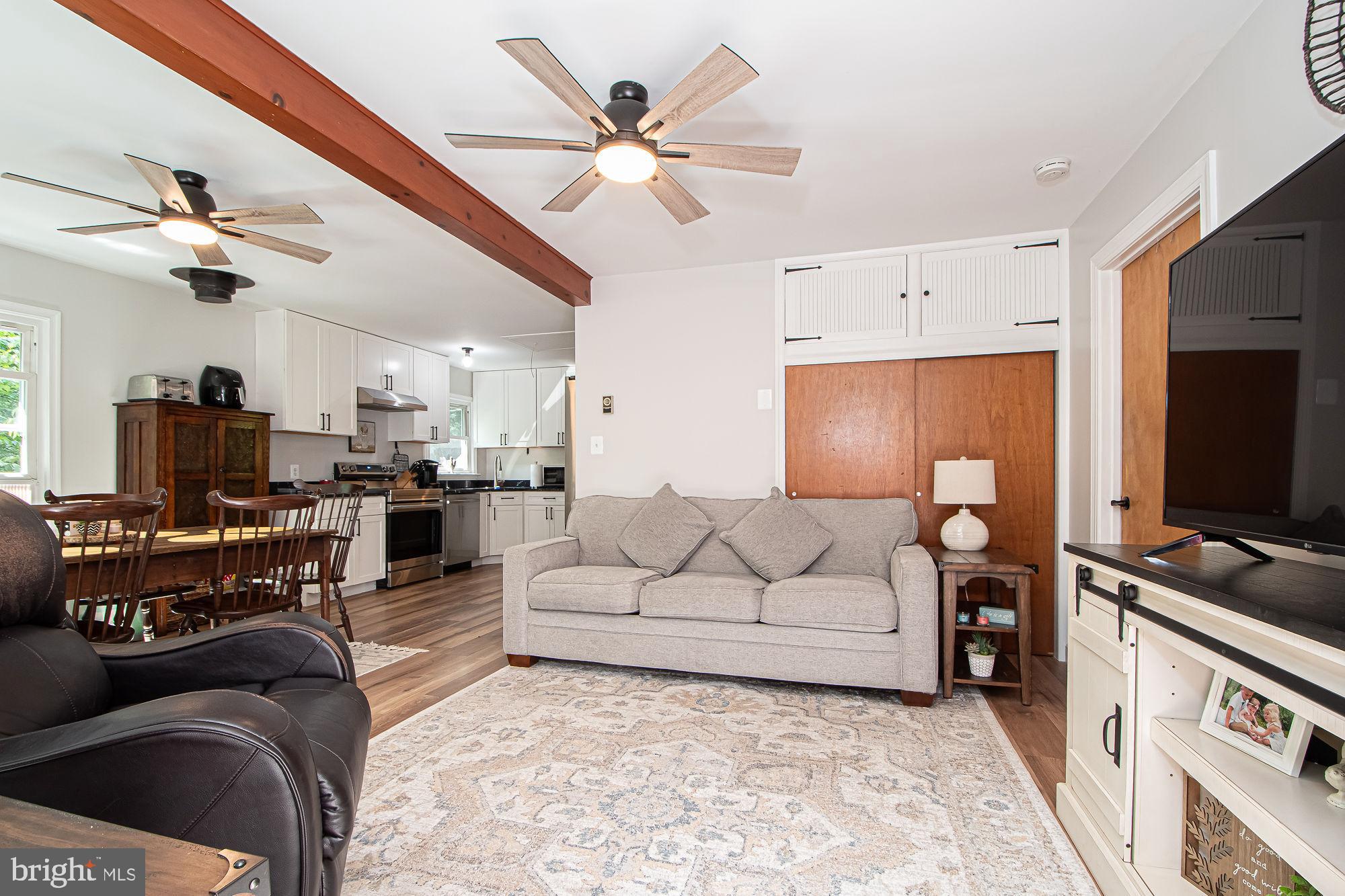 61 Mt Marshall Road Washington, VA 22747 - Photo 24 of 54 a living room with furniture kitchen view and a chandelier