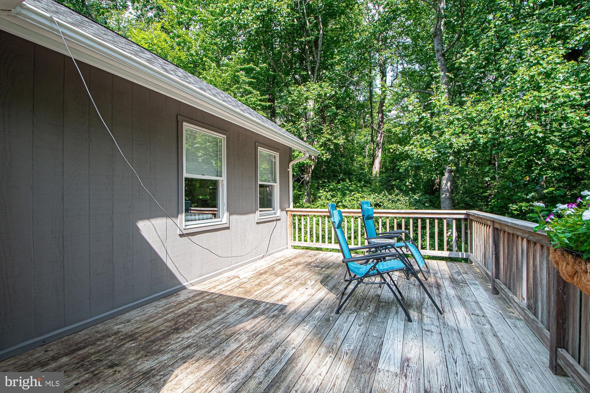 61 Mt Marshall Road Washington, VA 22747 - Photo 45 of 54 a balcony with wooden floor table and chairs
